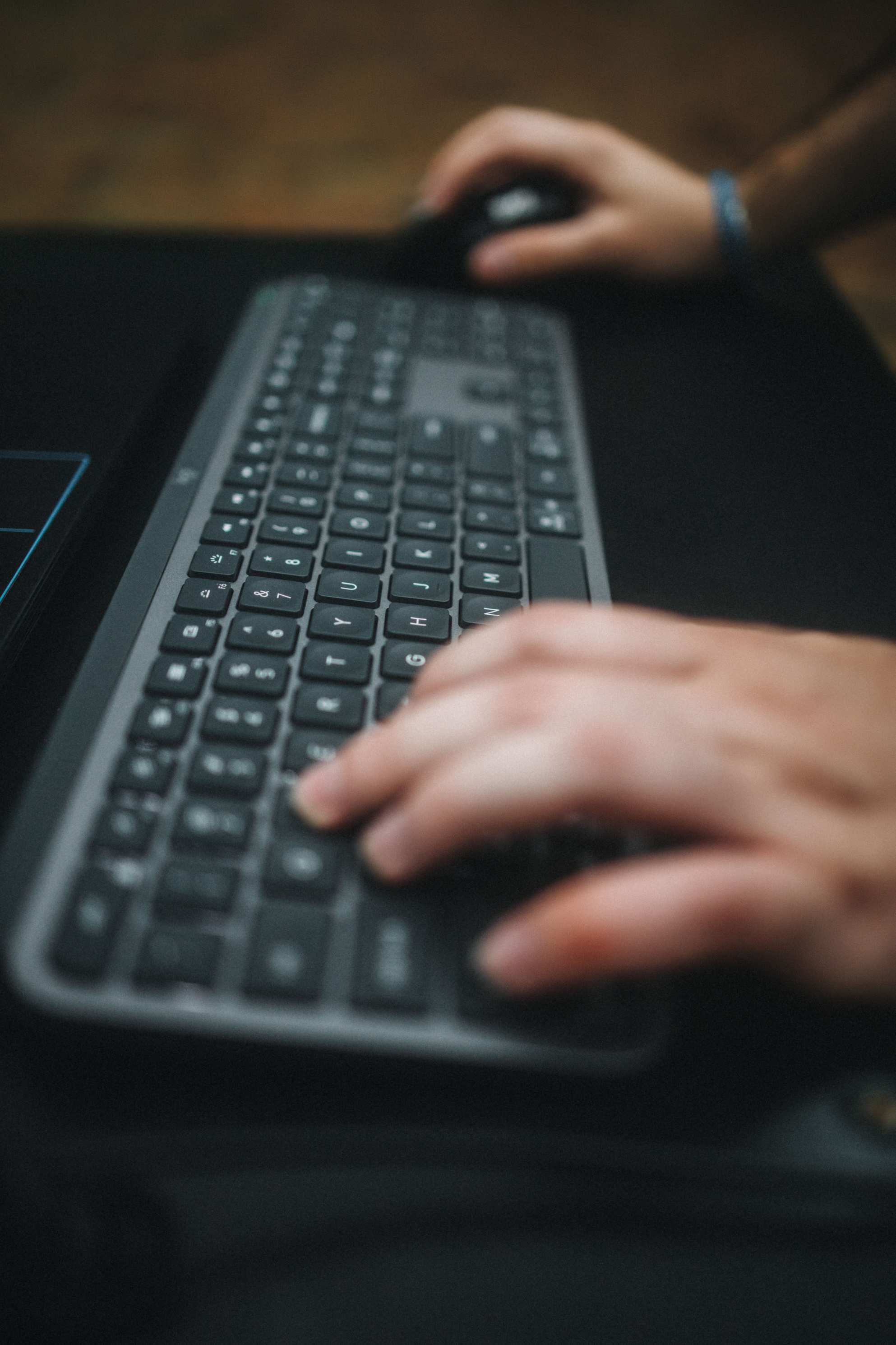 Hands typing on a laptop keyboard